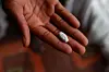 A patient shows a Vulante tablet, a medication and specifically a combination of tenofovir disoproxil fumarate and lamivudine, used for the treatment of HIV infection in adults aged 18 years and older at his home in Msogwaba township near Mbombela on March 12. [AFP/YONHAP]