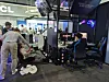 Visitors try out TCL’s gaming monitor. [LEE WOO-RIM]
