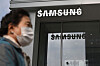 A woman walks past the Samsung logo in front of a Samsung Electronics store in Seoul on October 31, 2023. [AFP/YONHAP]