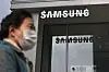 A woman walks past the Samsung logo in front of a Samsung Electronics store in Seoul on October 31, 2023. [AFP/YONHAP]