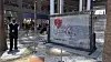 A slab of wall art, The ″Battle to Survive a Broken Heart,″ created by the artist Banksy, sits on display inside the Brookfield Place atrium on April 29 in New York. The nearly four-ton piece will be auctioned off on May 21. [AP/YONHAP]