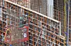 A worker operates machinery at an apartment construction site in Seoul on Aug. 11. [YONHAP]