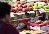 A shopper looks at fruit displayed at a traditional market in Seoul on Aug. 21. [YONHAP]
