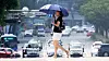 A person holds a sun umbrella while crossing the street in Daegu on July 28, 2023. [NEWS1]