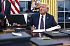 U.S. President Donald Trump signs numerous executive orders on the first day of his presidency in the Oval Office of the White House in Washington on Jan. 20. [EPA/YONHAP]