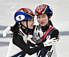Choi Min-jeong of Korea, left, congratulates teammate Kim Gil-li after Kim took the gold medal in the women's 1,500-meter short track speed skating event at the 2026 Winter Olympics at Milano Ice Skating Arena in Milan on Feb. 20. Choi won the silver medal. [JOONGANGILBO]