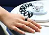 A customer tries on a Galaxy Ring in Titanium Black at Samsung Electronics' retail shop in western Seoul on Thursday. [YONHAP]