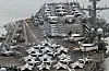 The Nimitz-class nuclear-powered aircraft carrier USS Theodore Roosevelt, right, departs Busan on Wednesday to take part in Freedom Edge, a new trilateral multi-domain exercise involving South Korea, the United States and Japan, in waters off the peninsula's southern coast. [NEWS1]