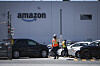 Workers are seen outside Amazon's YVR2 fulfillment center in Delta, British Columbia, Canada, on July 11. [AP/YONHAP]
