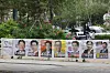 A campaign poster for the 21st presidential election is displayed near Gongdeok Station in Mapo District, western Seoul, with roses in full bloom behind it on May 15. [YONHAP]