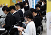 Job seekers wait for on-site interviews and employment consultations at a job fair held at Dongdaemun Design Plaza in Jung District, central Seoul, on Aug. 20. [YONHAP]