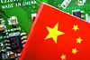 A Chinese flag is displayed next to a ″Made in China″ sign seen on a printed circuit board with semiconductor chips. [REUTERS]