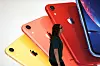 An Apple Store employee walks past an illustration of iPhones at the new Apple Carnegie Library during the grand opening and media preview in Washington, U.S., May 9, 2019. [REUTERS/YONHAP]