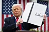 U.S. President Donald Trump holds a signed executive order after delivering remarks on reciprocal tariffs during an event in the Rose Garden entitled ″Make America Wealthy Again″ at the White House in Washington on April 2. [AFP/YONHAP]