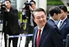 Former President Yoon Suk Yeol looks at his supporters as he appears at the Seoul Central District Court in southern Seoul on May 26 to attend the fifth hearing of a trial over insurrection charges in connection with his declaration of martial law. [JOINT PRESS CORPS]