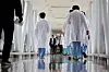 Medical professionals walk inside a corridor at a general hospital in Seoul on Monday. [YONHAP]