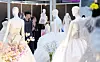 Engaged couples look at wedding dresses during a wedding exposition at Coex in southern Seoul on July 6. [NEWS1]