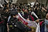 Photographers take picture of the members of League of Social Democrats scuffling with police outside the West Kowloon Magistrates' Courts ahead of the national security trail for the pro-democracy activists in Hong Kong, on Feb. 6, 2023. [AP/YONHAP]