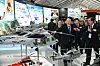 President Yoon Suk Yeol, front left, visits a booth for the Korea Aerospace Industries (KAI), as KAI CEO Kang Goo-young, front right, briefs him on the latest aircraft during the Seoul International Aerospace & Defense Exhibition (ADEX) at Seoul Air Base in Seongnam, Gyeonggi, Tuesday. [PRESIDENTIAL OFFICE]