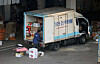 A delivery worker organizing packages inside a delivery truck in Seoul on Tuesday. [YONHAP]