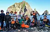 Haenyeo, or female divers, from Jeju and Ulleungdo pose for a commemorative photo on Dokdo after performing a diving demonstration off its pebble beach on Aug. 8. [JEJU PROVINCIAL GOVERNMENT]