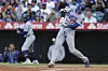 Los Angeles Dodgers designated hitter Shohei Ohtani makes contact with the ball as Mookie Betts watches on deck during the first inning of a baseball game against the Los Angeles Angels on Aug. 11, 2025, in Anaheim, California. [AP/YONHAP]
