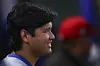 Los Angeles Dodgers designated hitter Shohei Ohtani reacts in the dugout during the fifth inning of a baseball game against the Los Angeles Angels on Aug. 11, 2025, in Anaheim, Calif. [AP/YONHAP]