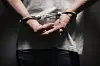 A handcuffed man [GETTY IMAGES BANK]