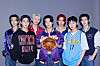 Enhypen members pose for a photo with merchandise from NBA teams [NBA]