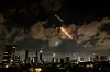 An anti-missile system operates as missiles are launched from Iran, as seen from Tel Aviv, Israel, on June 18. [REUTERS/YONHAP]