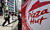A passerby walks by a Pizza Hut store in Seoul on Tuesday. [NEWS1]