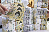 Won and dollar bills are stacked at Hana Bank's offices in Jung District, central Seoul, on April 17. [NEWS1]