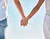A couple holding hands [GETTY IMAGES]