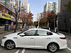 A white sedan is seen parked horizontally in front of a vehicle barrier at the entrance to an apartment complex in Bucheon, Gyeonggi, in this photo posted on an online community. [SCREEN CAPTURE]