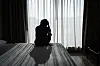 Lonely young man feeling depressed and stressed sitting in the dark bedroom. [GETTY IMAGES]