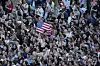 People hold up a U.S. flag as the newly elected Pope Leo XIV appears at the balcony of St. Peter's Basilica at the Vatican on May 8. [AP/YONHAP]