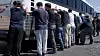 Detainees stand against a bus before being handcuffed, during a raid by federal agents where about 300 Koreans were among 475 people arrested at the site of a $4.3 billion project by Hyundai Motor and LG Energy Solution to build batteries for electric cars in Ellabell, Georgia, U.S., Sept. 4, in a still image taken from a video. [U.S. IMMIGRATION AND CUSTOMS ENFORCEMENT]