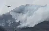 A helicopter joins firefighting efforts to suppress a wildfire in Uiseong County in North Gyeongsang on March 24. [YONHAP]