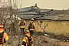Firefighters examine the scene as they extinguish a large wildfire in Goesan-ri in Uiseong County, North Gyeongsang, on March 22. [YONHAP]