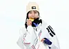 Choi Ga-on of Korea bites down on the gold medal in the women’s snowboard halfpipe final at the 2026 Milan-Cortina Winter Olympics on Feb. 12. [NEWS1]