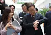 President Lee Jae-myung looks at his wristwatch while walking with reports to the presidential office in Yongsan District, central Seoul, on June 10. [JOINT PRESS CORPS]