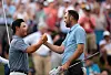 Tom Kim, left, shakes hands with Scottie Scheffler during the final round of the Travelers Championship at TPC River Highlands in Cromwell, Connecticut on Sunday. [GETTY IMAGES]