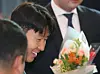 Tottenham Hotspurs captain Son Heung-min receives flowers from fans as he arrives at Incheon International Airport in the afternoon on May 27. [YONHAP]