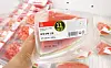 Individually wrapped watermelon slices, designed for single-person households, are sold at a supermarket on June 16. [YONHAP]