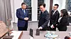 President Lee Jae Myung examines the Xiaomi smartphone presented to him by Chinese President Xi Jinping on Nov. 2. [YONHAP]