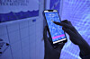 A participant in an escape room game at Real World Seongsu solves a mission using a smartphone. [REAL WORLD SEONGSU]