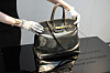 An auction officer displays the original Birkin bag created by Hermes for Jane Birkin in 1984, prior to its auction in Paris on July 10. [AP/YONHAP]