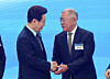 President Lee Jae Myung, left, shakes hands with Hyundai Motor Group Executive Chair Euisun Chung during an investment pledge ceremony in Saemangeum, North Jeolla, on Feb. 27. [YONHAP]