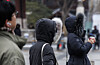People head to work near Seoul's Gwanghwamun Station amid strong wind and snow falling on Jan. 31. [YONHAP]