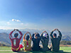 Travelers pose for a photo before boarding a paraglider during a package tour organized by the travel agency Jigu-noriter. [JIGU-NORITER]